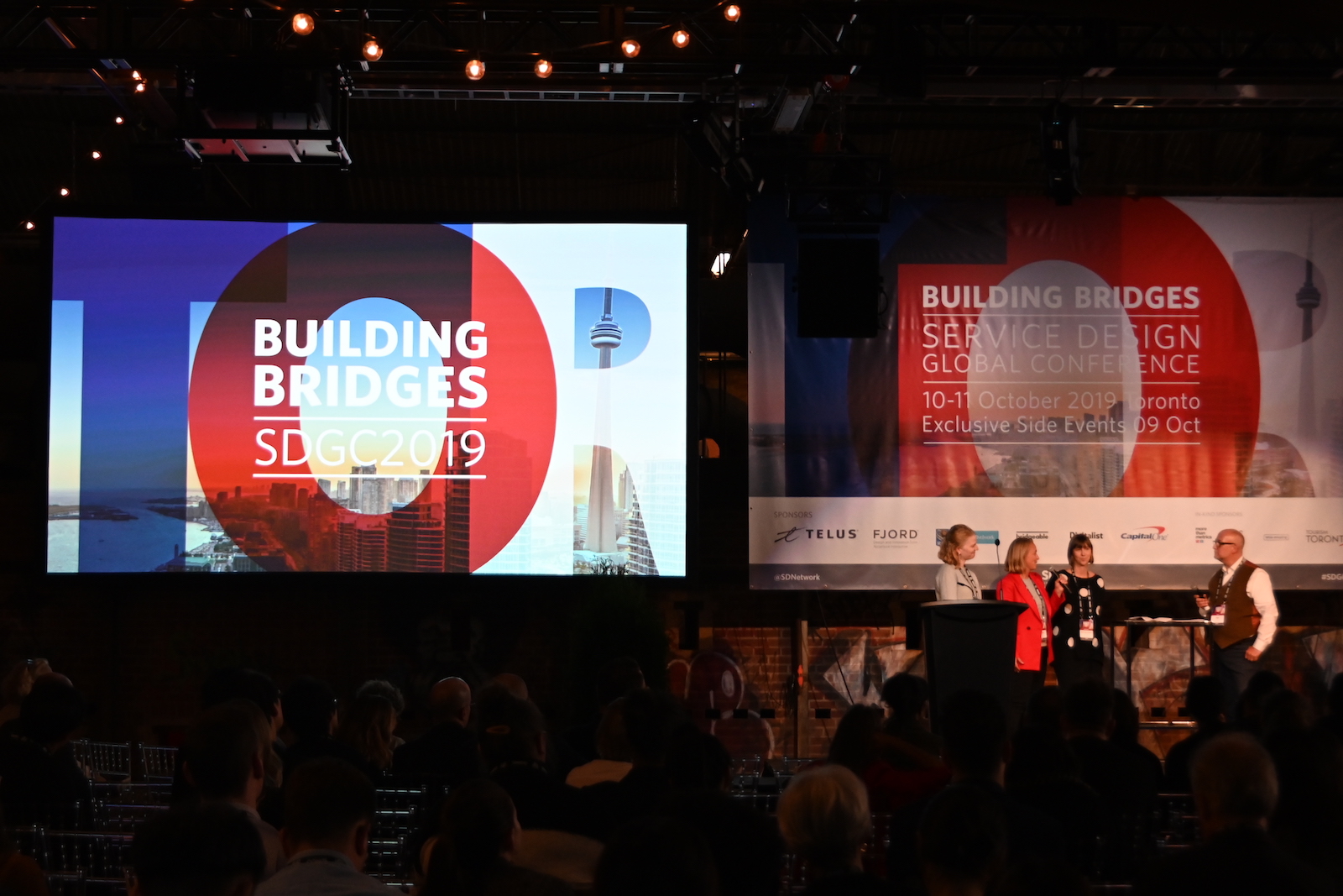 SDGC stage with "Building Bridges" conference slides