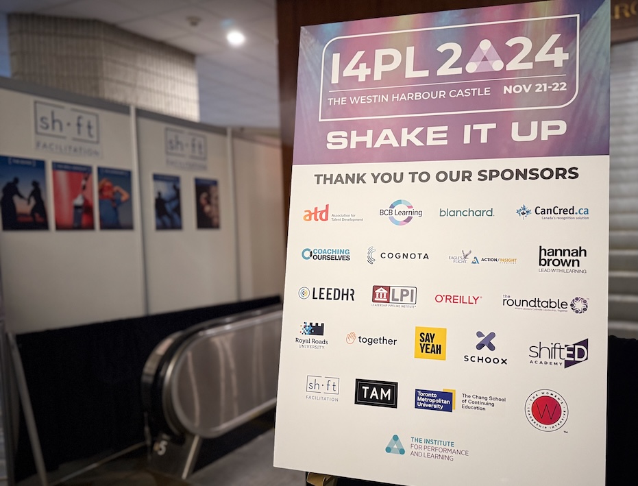 The I4PL printed sponsor board highlights a series of key sponsors, with about 25 sponsor logos, including Say Yeah, alongside the conference theme, "Shake it up!".